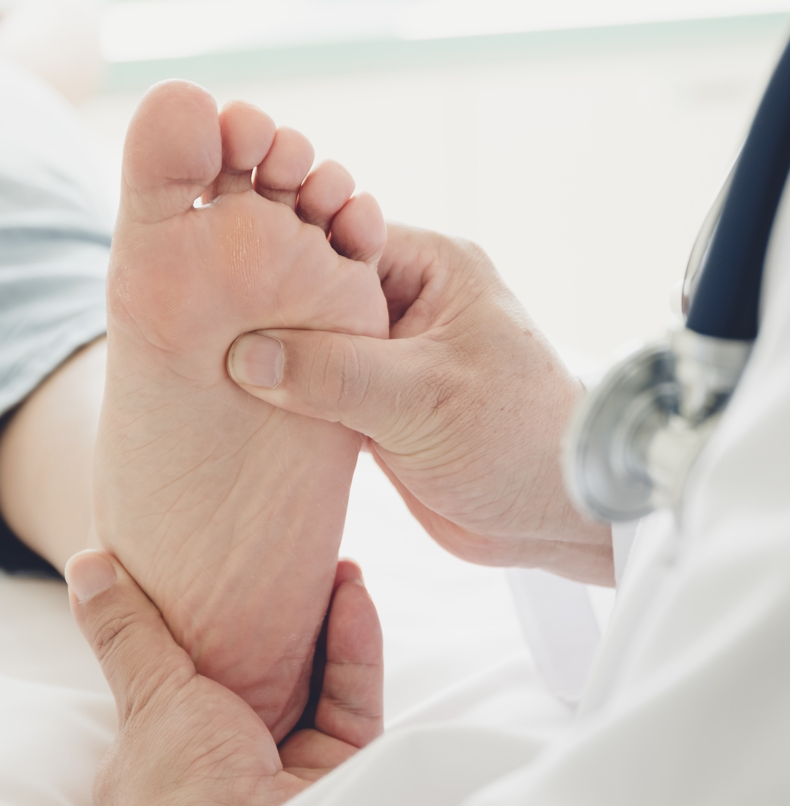 doctor touching patients foot