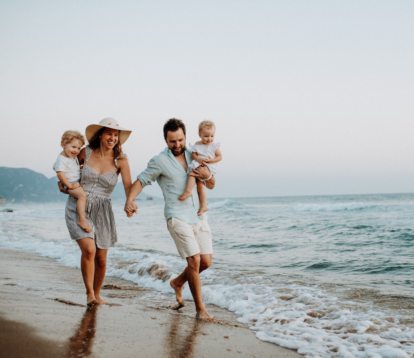 family running on beach