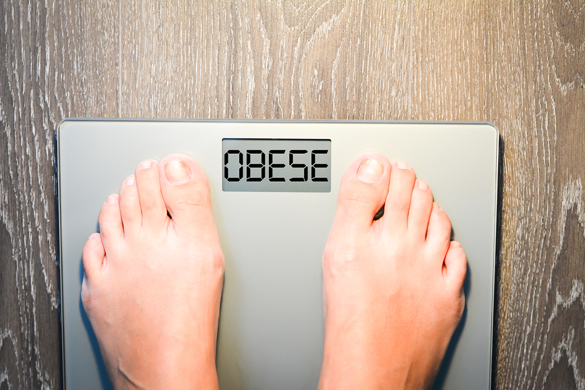 lose weight concept with person on a scale lose weight concept with person on a scale