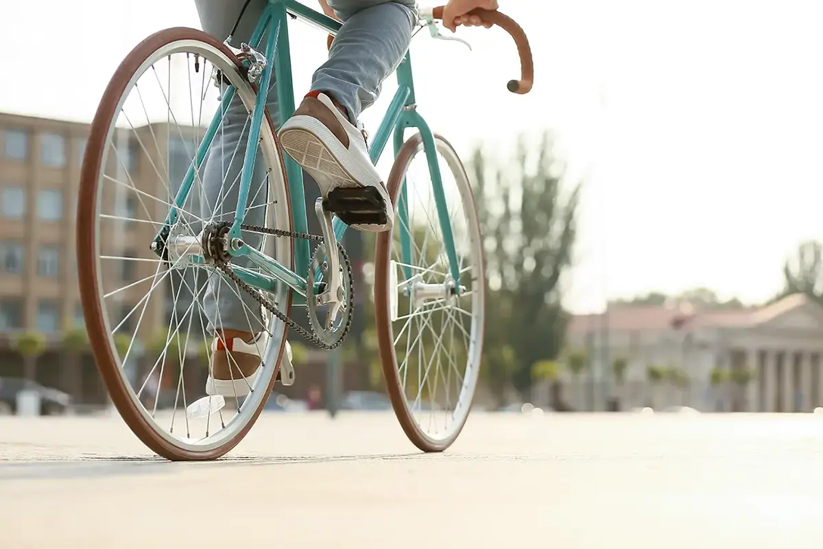 young man riding bicycle on city square young man riding bicycle on city square