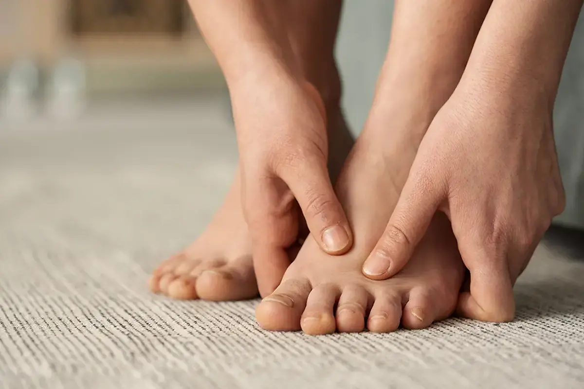 young woman feeling pain in her foot young woman feeling pain in her foot